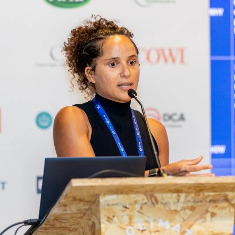 Elissama Menezes speaking at a podium